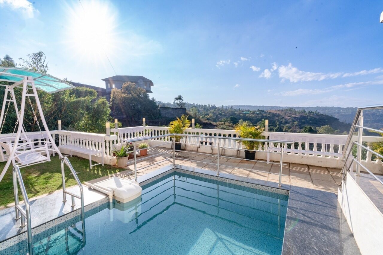 Pool with garden swing and hill views