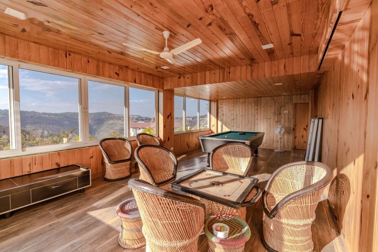 Wood-panelled games room with pool table